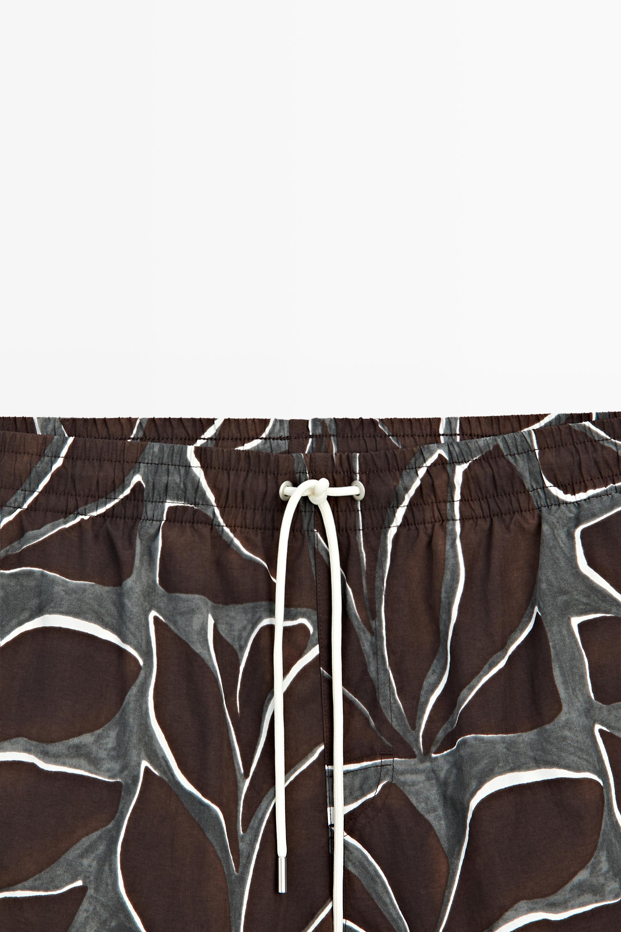 Tropical print swimming trunks